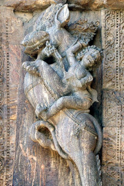 Konark Sun Temple in Odisha, India. It is a 13th-century CE sun temple at Konark about 35 K.M. northeast from Puri on the coastline of Odisha, India. Ancient ruin statue of Konark Sun temple. Konark Sun Temple in Odisha, India. Ancient ruin statue of Konark Sun temple. Erotism and origin of kamasutra in Indian sculpture. Erotic sculpture of Konark temple. The temple is assigned to king Narasingha deva I. Konark Sun Temple is a 13th-century temple at Konark about 35 km from Puri of Odisha, India. 
     This temple dedicated to the Hindu god "Surya". Sun Temple also known as the Black Pagoda. The entire temple has been conceived as a chariot of the sun god with 24 wheels, dragged by 7 horses. chariot wheel at konark sun temple india stock pictures, royalty-free photos & images