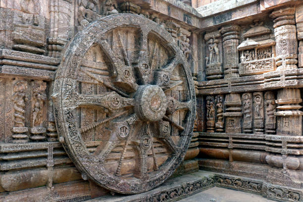 Ancient chariot Wheel, Konark Sun Temple, Orissa. Konark Sun Temple in Odisha, India. Ancient ruin statue of Konark Sun temple. Erotism and origin of kamasutra in Indian sculpture. Erotic sculpture of Konark temple. The temple is assigned to king Narasingha deva I. Konark Sun Temple is a 13th-century temple at Konark about 35 km from Puri of Odisha, India. 
     This temple dedicated to the Hindu god "Surya". Sun Temple also known as the Black Pagoda. The entire temple has been conceived as a chariot of the sun god with 24 wheels, dragged by 7 horses. chariot wheel at konark sun temple india stock pictures, royalty-free photos & images