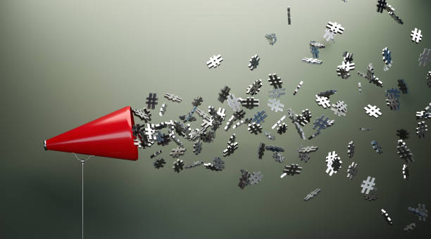 Red Megaphone And Silver Hashtag Symbols In Front Of Gray Wall