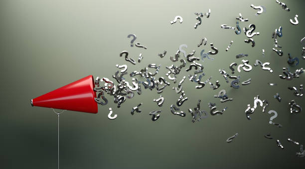 istock Red Megaphone And Silver Question Marks In Front Of Gray Wall 1151630751