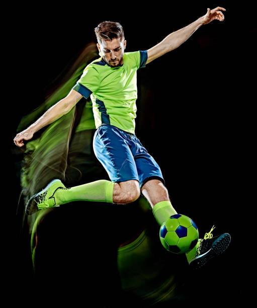 istock caucasian soccer player man isolated black background light painting 1151633596