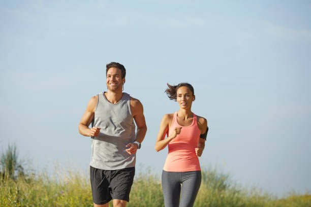 istock Determined couple jogging at park on sunny day 1151637568