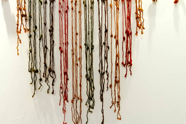 A collection of colorful hair ties with beads in a box which are elastic and come in a variety of colors, including pink, yellow, blue, and purple