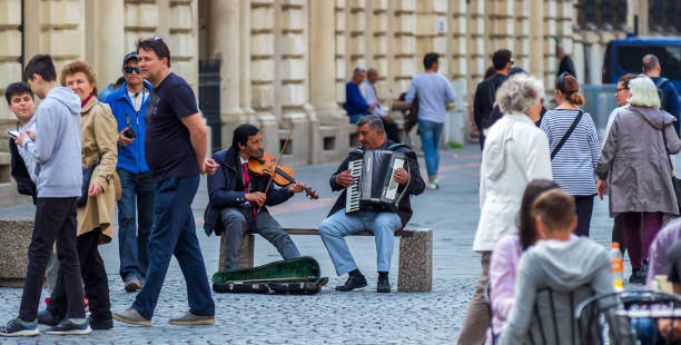 Bucharest, Romania - May 02, 2019: Two Gypsy singers play on the Lipscani street in the old city of Bucharest, Romania.