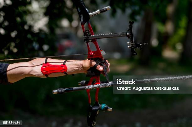 Archer Pulls On The Sport Bow String Taking Aim At His Target At The Competition Stock Photo - Download Image Now