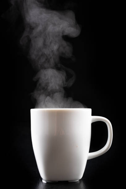 istock White mug and water vapor. Freshly brewed hot drink. Black background. 1151654865