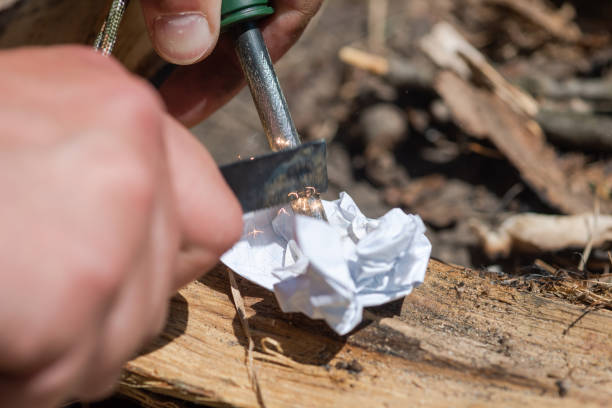 Make fire by friction with with flint and steel