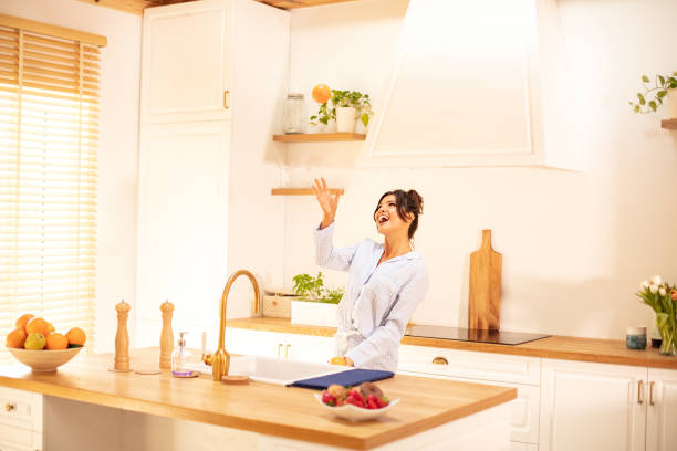 istock Cute woman doing orange juice. 1151657443