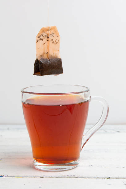 istock glass cup with tea bag on white table 1151658357