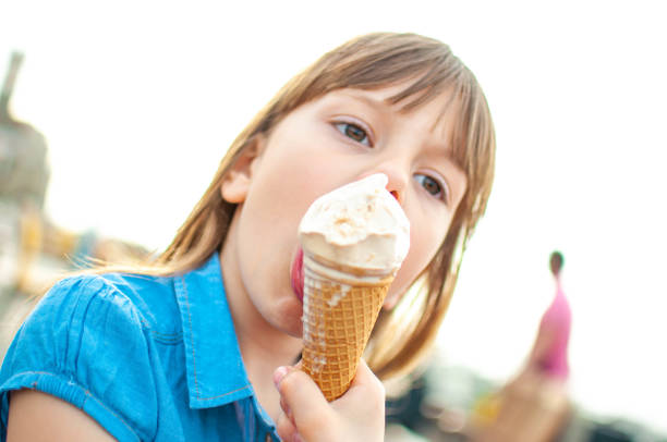 istock Little girl eating ice cream 1151658604