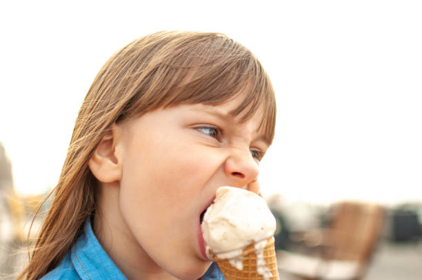 istock Little girl eating ice cream 1151658621