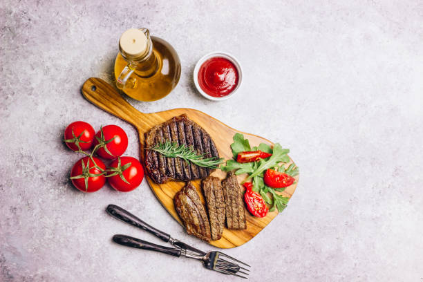 istock grilled beef steaks with spices on wooden cutting board 1151659263