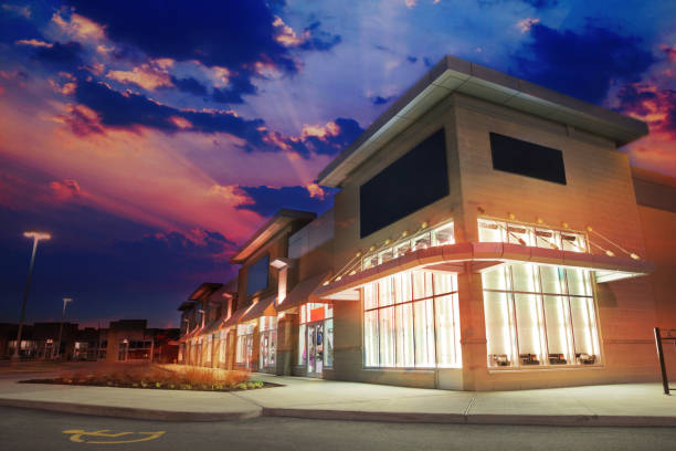 Illuminated Marketplace Store building at Sunset Illuminated Stores at Night window shopping at night stock pictures, royalty-free photos & images