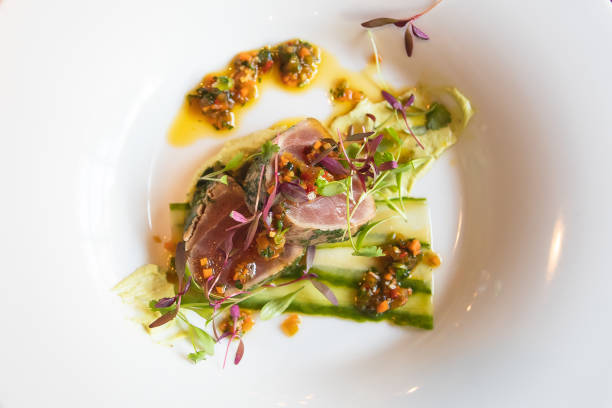 seafood appetizer, delicious slices of tuna with herbs and sauce