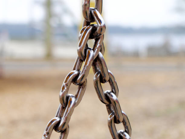 Iron chains connected to each other forming a triangle. stock photo