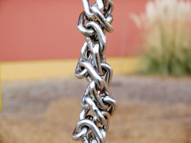 Twisted Iron chains on the red background. stock photo