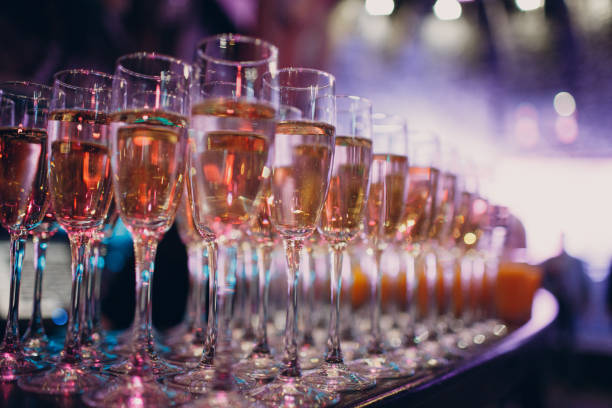 istock Glasses with champagne in a multi-colored light party 1151660889