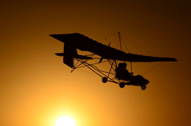 istock Ultralight airplane at sunset. 1151662682