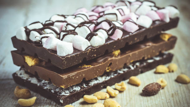 istock Blocks of rustic chocolate with nuts, coconut, honeycomb and marshmallows. 1151664333