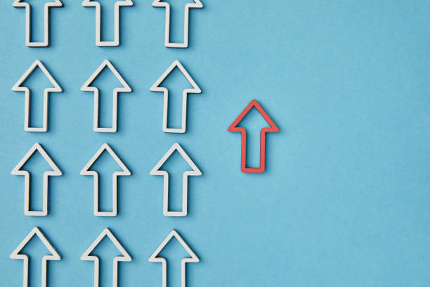 istock top view of vertical rows with white pointers near red arrow on blue background 1151668445