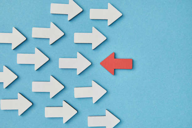 istock top view of red horizontal pointer opposite white arrows on blue background 1151668450