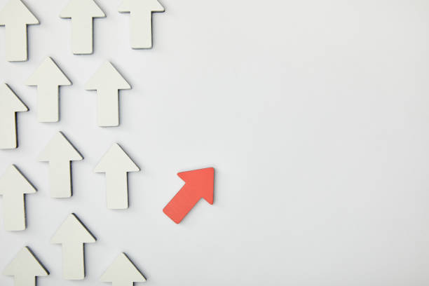 istock top view of red arrow near white pointers on grey background 1151668473