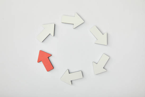 istock top view of white arrows and red pointer in circle on grey background 1151668482