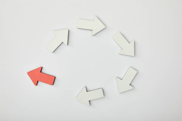 istock top view of red arrow in circle with white pointers on grey background 1151668490