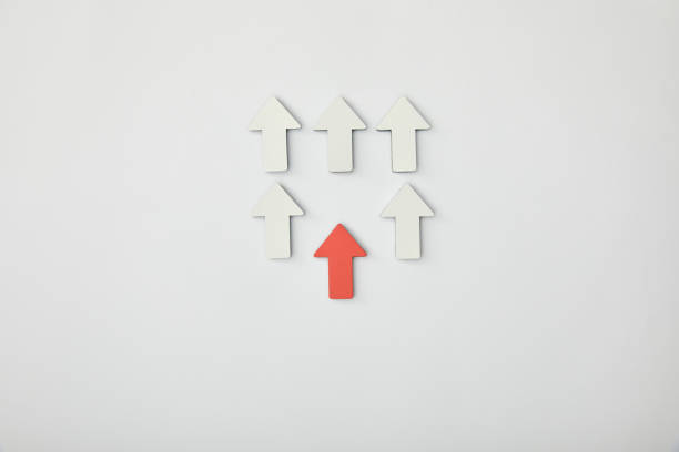 istock top view of red arrow near rows with white pointers on grey background 1151668492