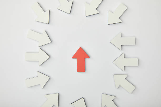 istock top view of red arrow in ellipse made with white pointers on grey background 1151668497