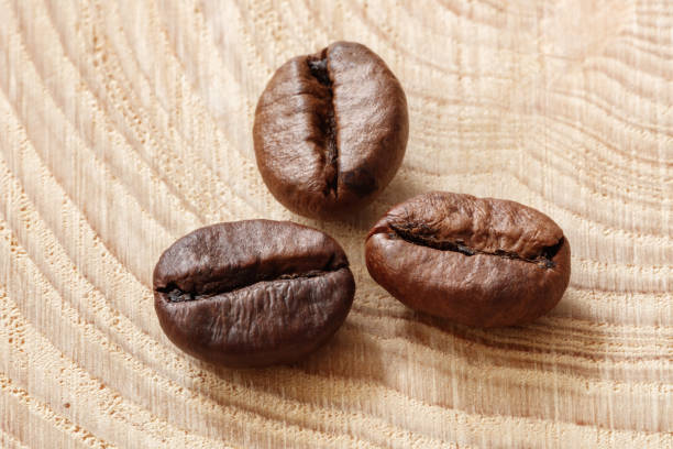 Coffee  beans on natural wooden texture background. Coffee background or texture concept.