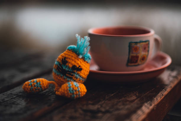 istock Flower symbol on tea cup with a toy 1151669984