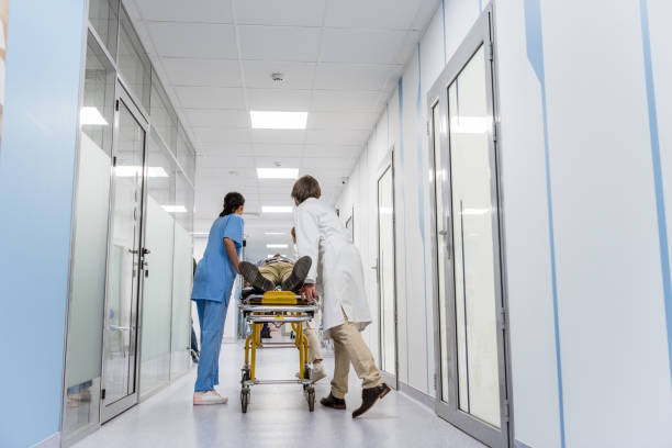 istock Doctors and nurse transporting unconscious patient on gurney 1151672466