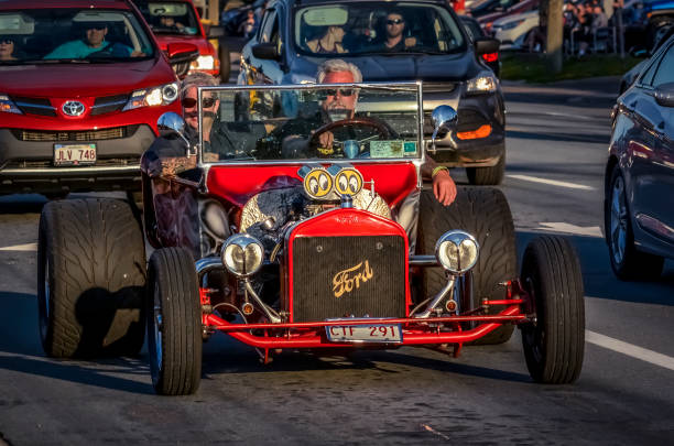 1923 Ford T-Bucket hot rod cruising on Mountain Road Moncton, New Brunswick, Canada - July 8, 2017 : Driver and passenger take a cruise in 1923 Ford T-Bucket hot rod. During 2017 Atlantic Nationals Automotive Extravaganza on Saturday evening classic cars cruise on Mountain Road. cruising hot rods stock pictures, royalty-free photos & images