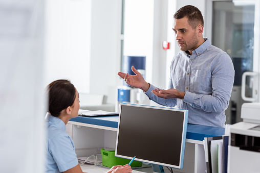 Upset patient talking to nurse in clinic