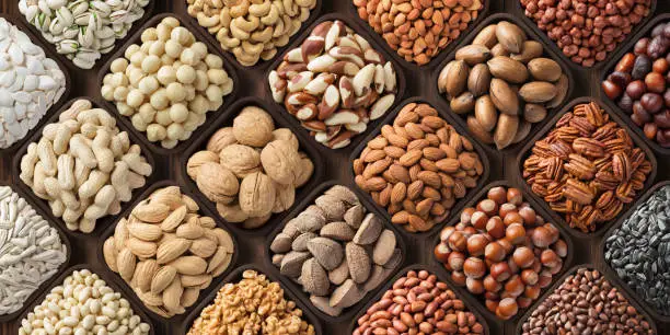 Photo of assorted nuts background, large mix seeds. raw food products: pecan, hazelnuts, walnuts, pistachios, almonds, macadamia, cashew, peanut and other