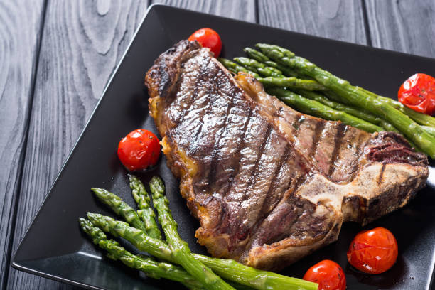 istock Grilled T-bone steak with asparagus and cherry tomatoes 1151678462