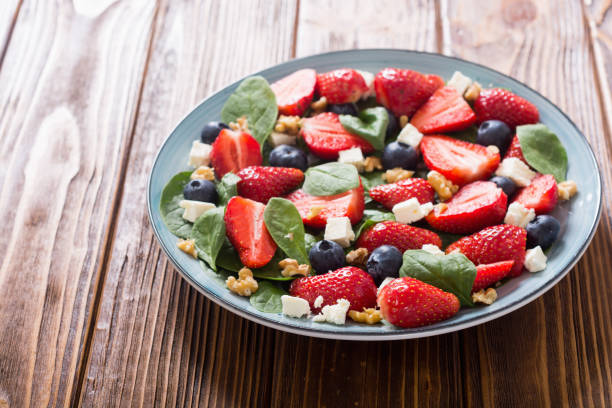 istock Summer Strawberry salad with spinach , cheese , nuts and blueberry 1151678504