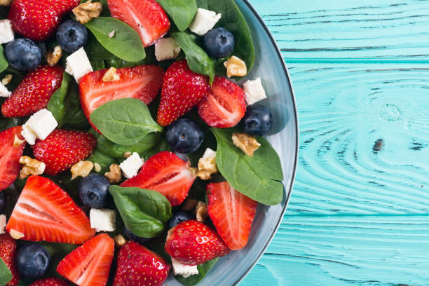 istock Summer Strawberry salad with spinach , cheese , nuts and blueberry 1151678510
