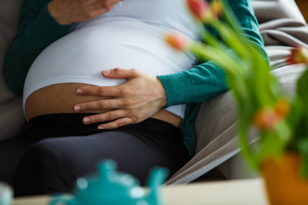 istock Holding her pregnant belly 1151683155