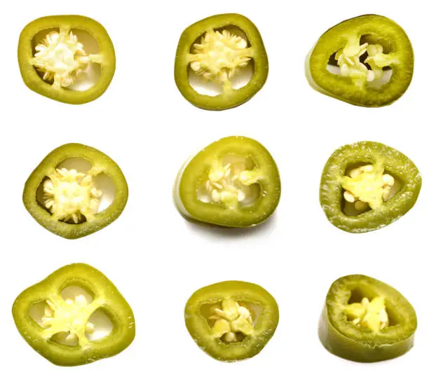 green jalapeno pepper slices isolated white background