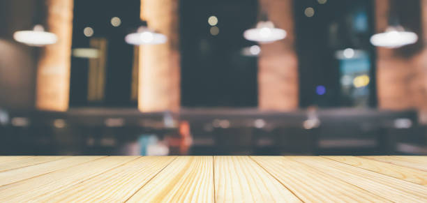 istock Empty wood table top with abstract blur cafe restaurant with abstract bokeh light defocused background 1151686367