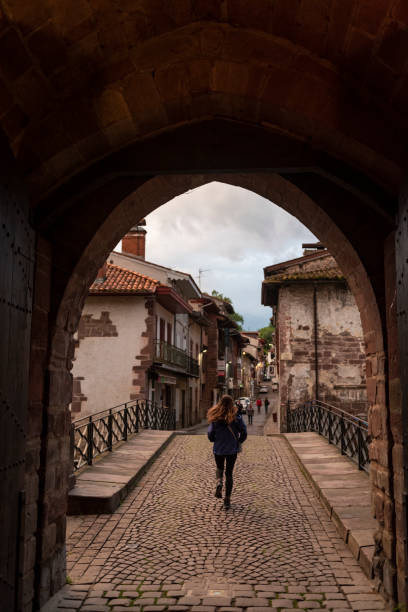 start des camino de santiago in saint-jean-pied-de-port, frankreich - women rear view one person arch stock-fotos und bilder