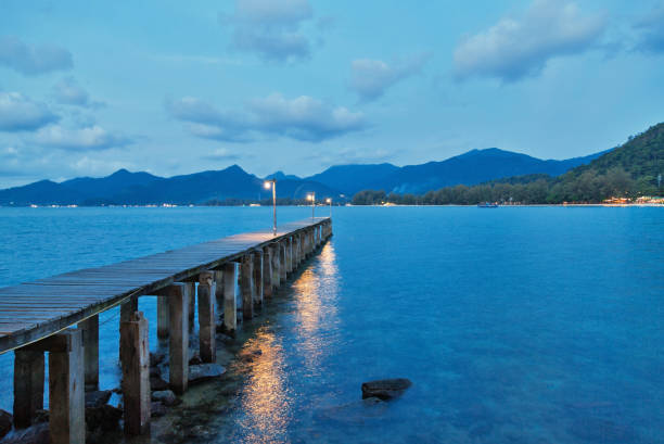 istock Bridge with lanterns across a small river at night. 1151702134