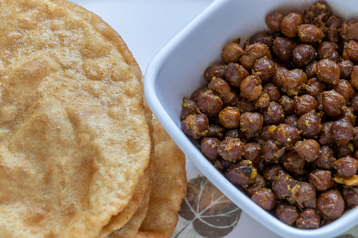 Kala Channa with Puri, Indian dish Or Black Chickpeas with fried bread. Selective focus.