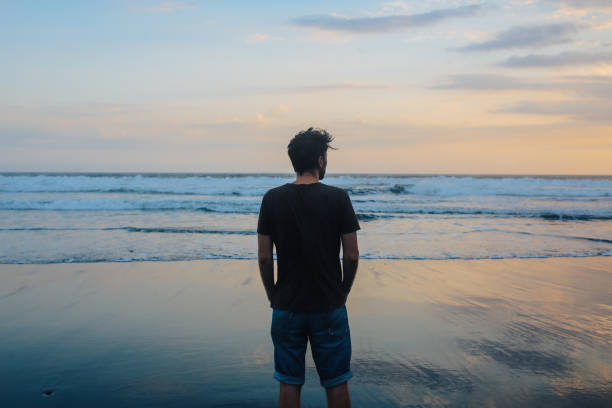 istock young man watching sunset in Bali, Indonesia 1151706325
