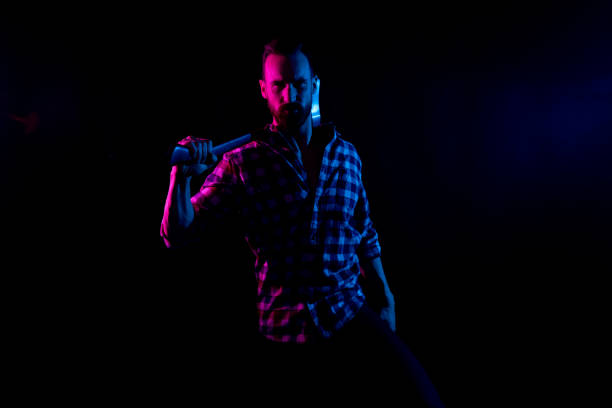 istock Sexy lumberjack in black background with gel lighting 1151707110