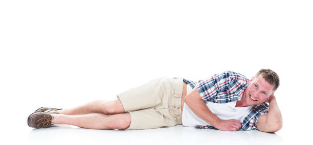 istock Handsome man in shirt and shorts is lying down and relaxing 1151708336