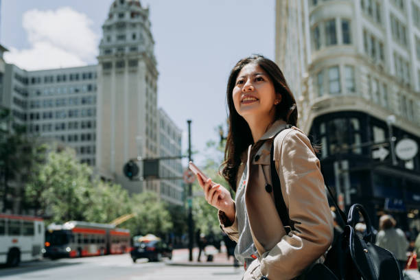 istock girl smiling looking aside holding cellphone 1151708439