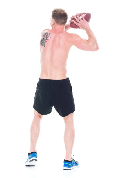 istock Handsome shirtless man holding a football 1151708512
